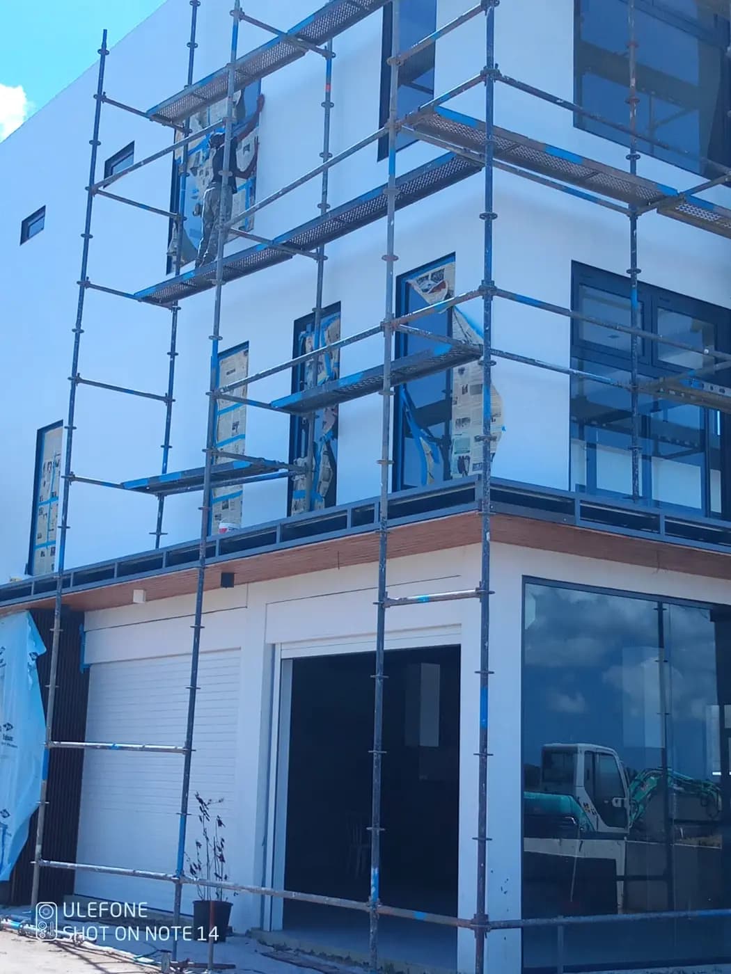 Glass façade installation with scaffolding