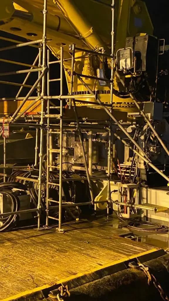 Scaffolding around deck equipment at night